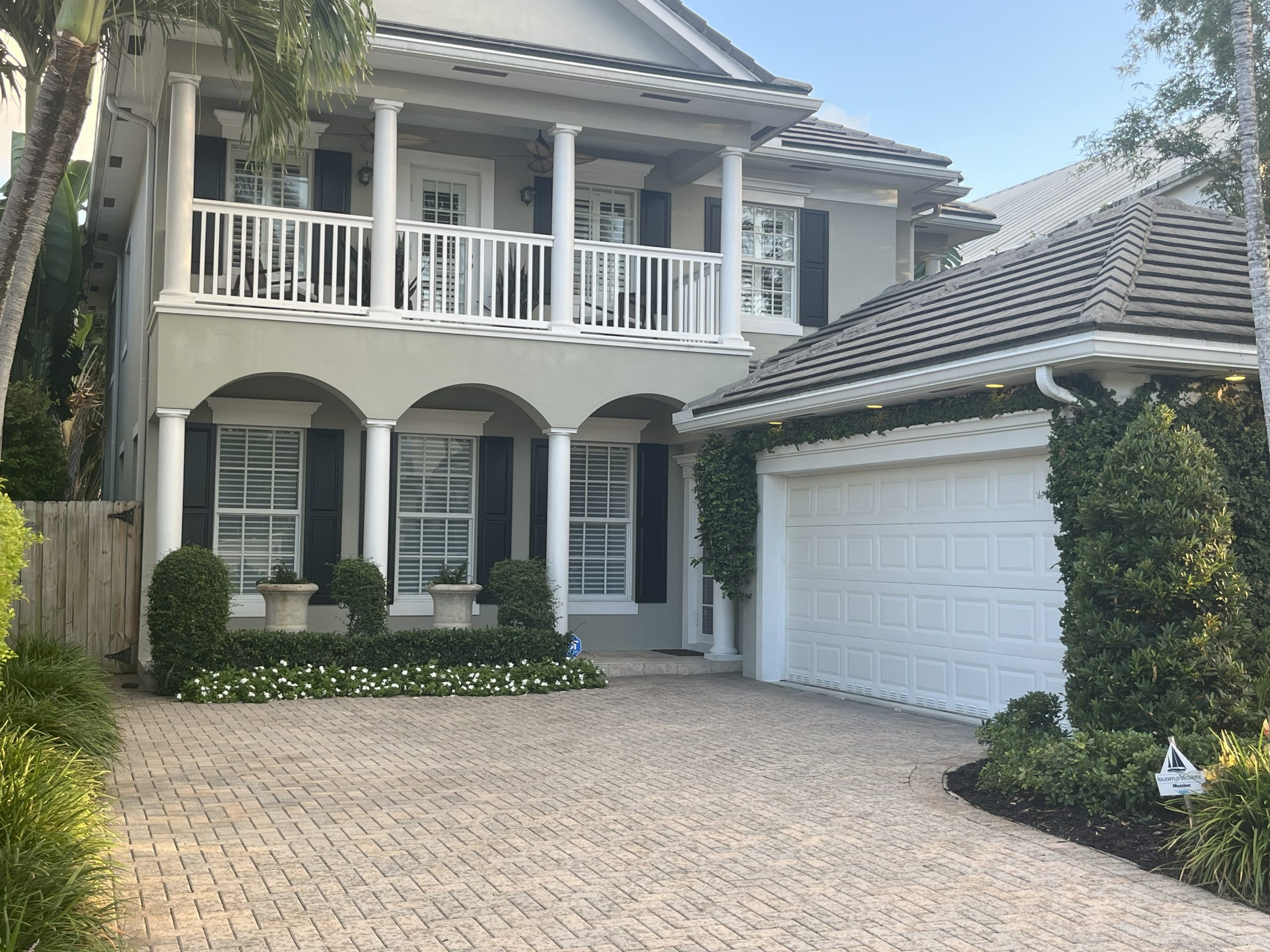 White garage doors on traditional home — West Palm Beach, FL